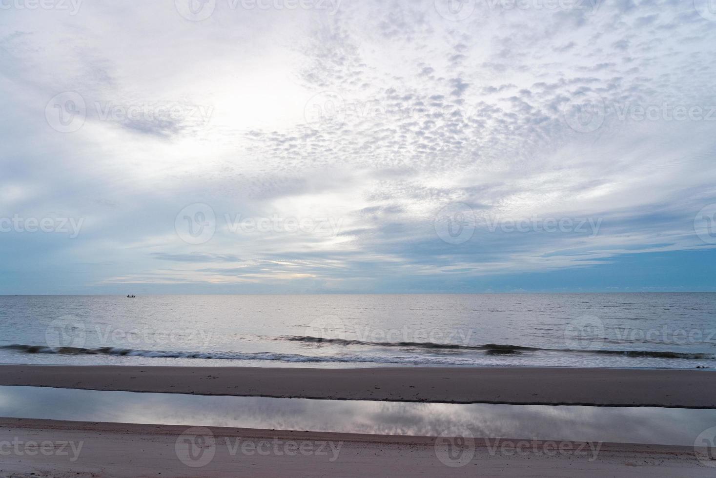 Landscape of Ocean with Reflection of Sky in Morning photo