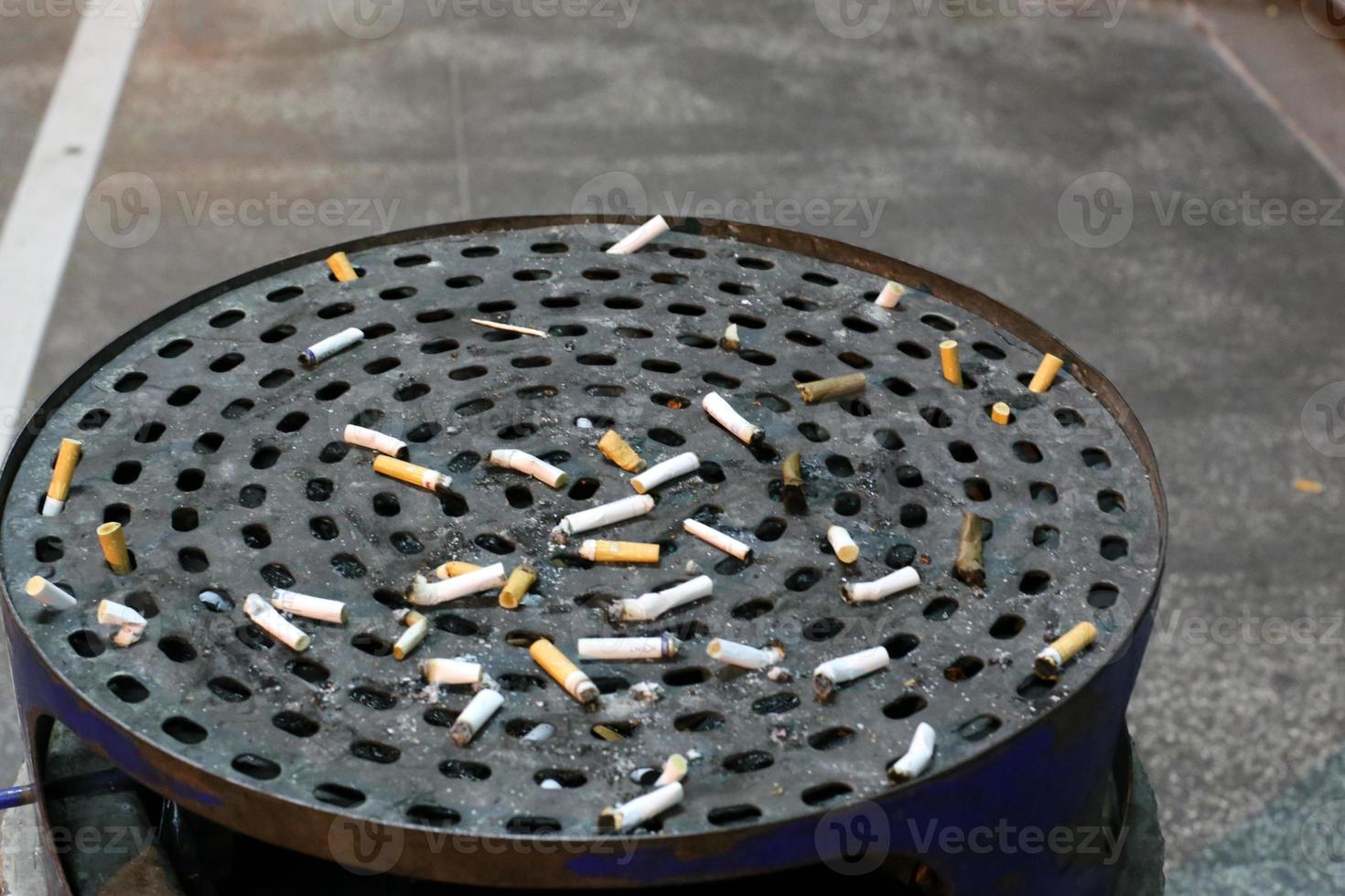 Ashtray - a container for tobacco ash, cigarette butts, cigars. photo