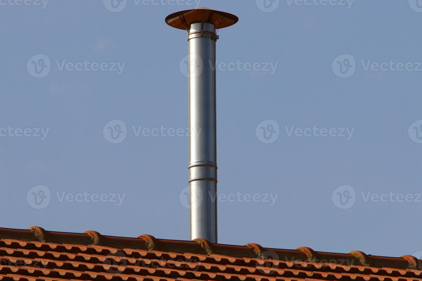 Chimney on the roof of the house photo