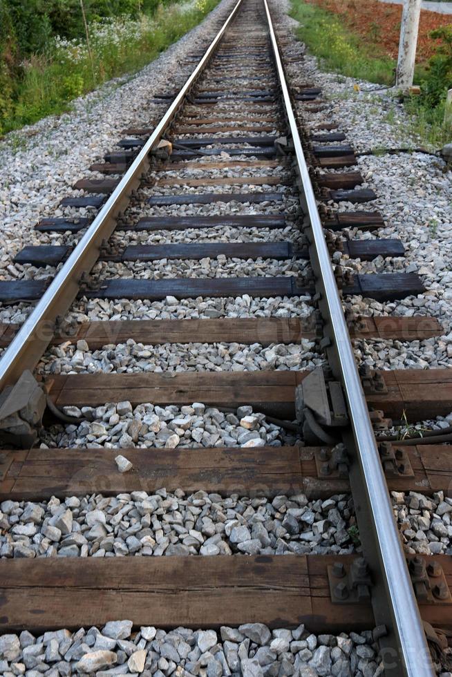 A road with rail tracks intended for the movement of railway rolling stock. photo