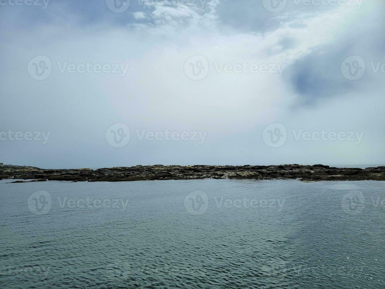 rocky shore off the coast of Maine United Statees photo