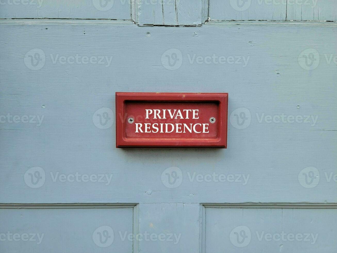 red private residence sign on blue wood door on home photo