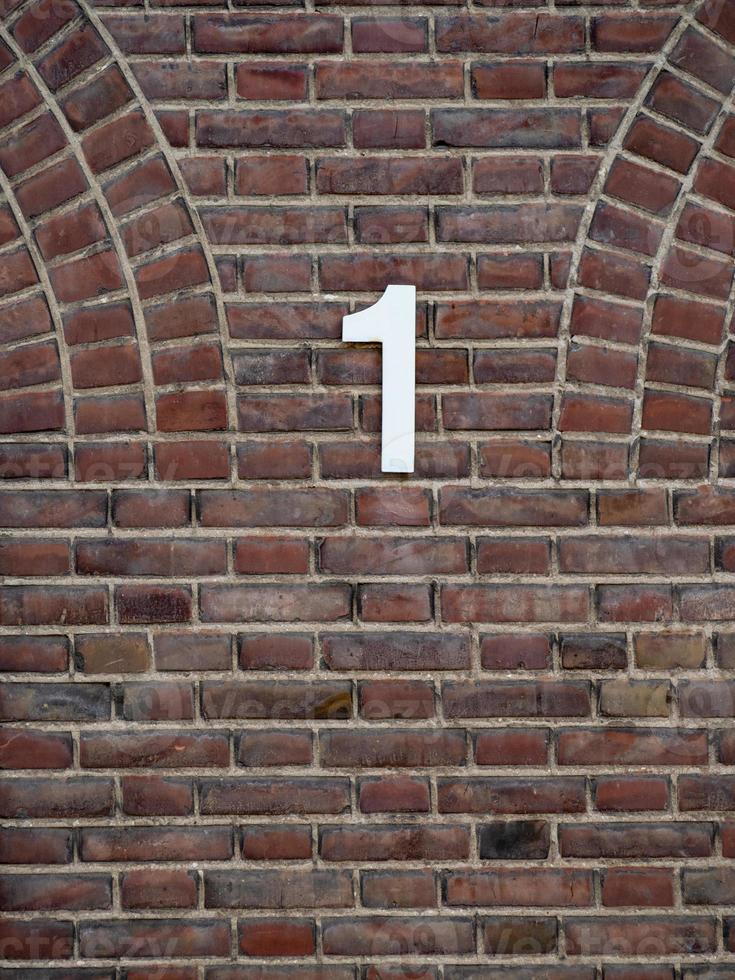 brick wall with house number 1 photo