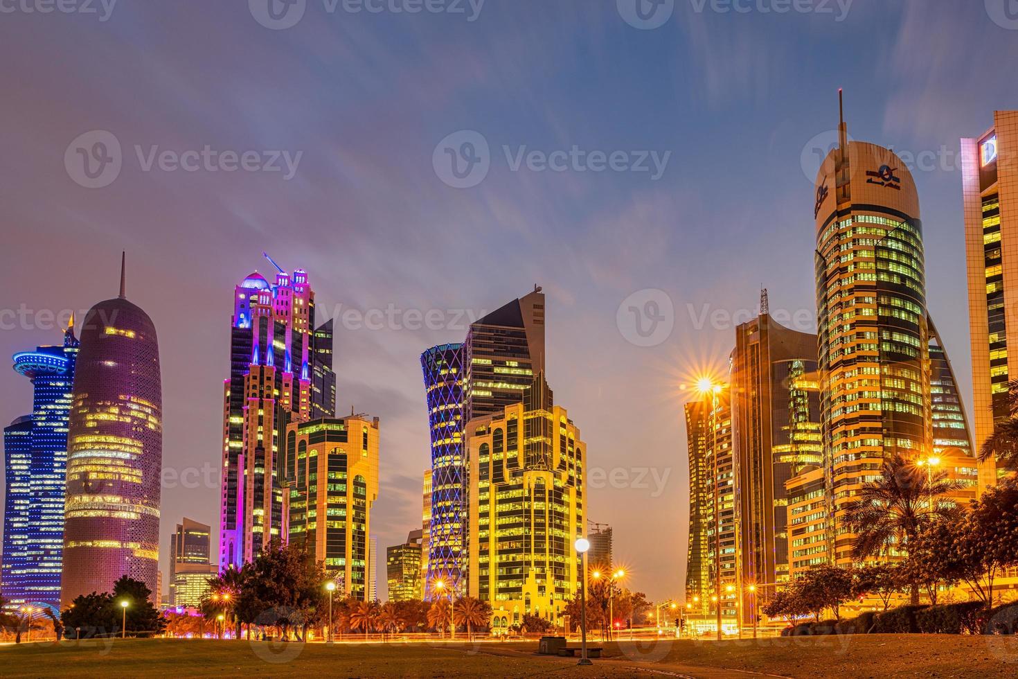 Doha skyline at dusk from Sheraton park  in West Bay financial district   in Doha Qatar with clouds in the sky photo
