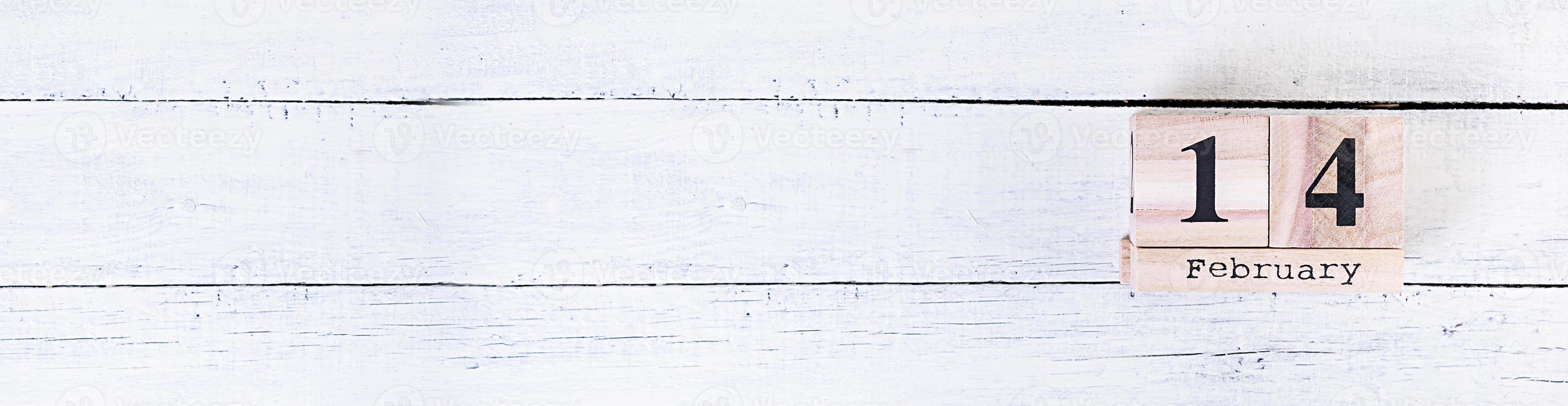 Valentine day. Wooden calendar with February 14 on it. photo