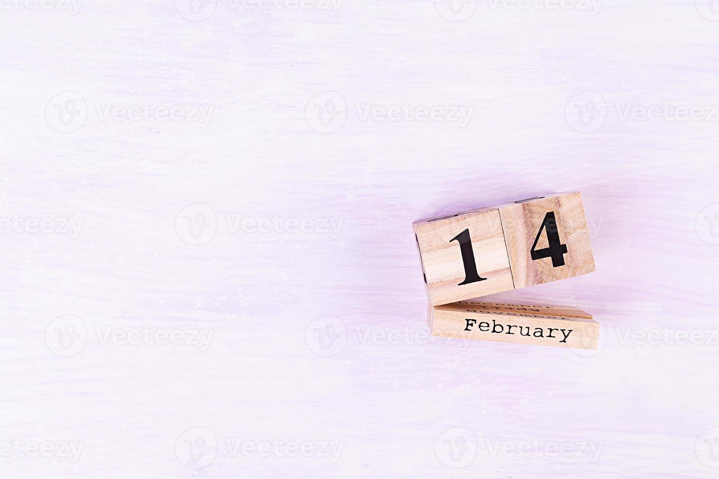 Valentine day. Wooden calendar with February 14 on it. photo