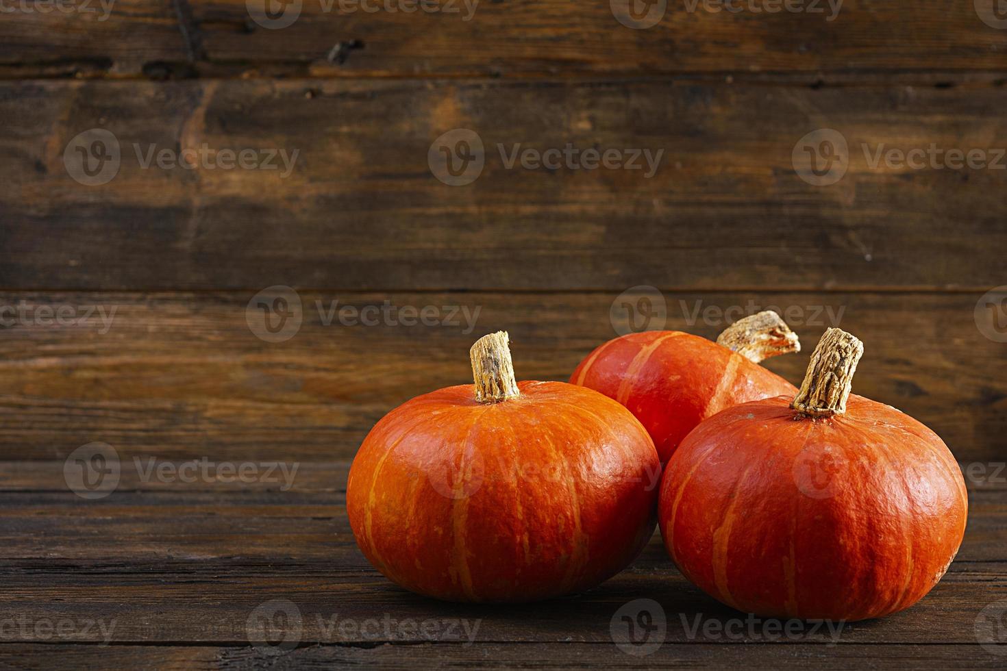 Mini pumpkins on wooden background. Thanksgiving day concept. photo