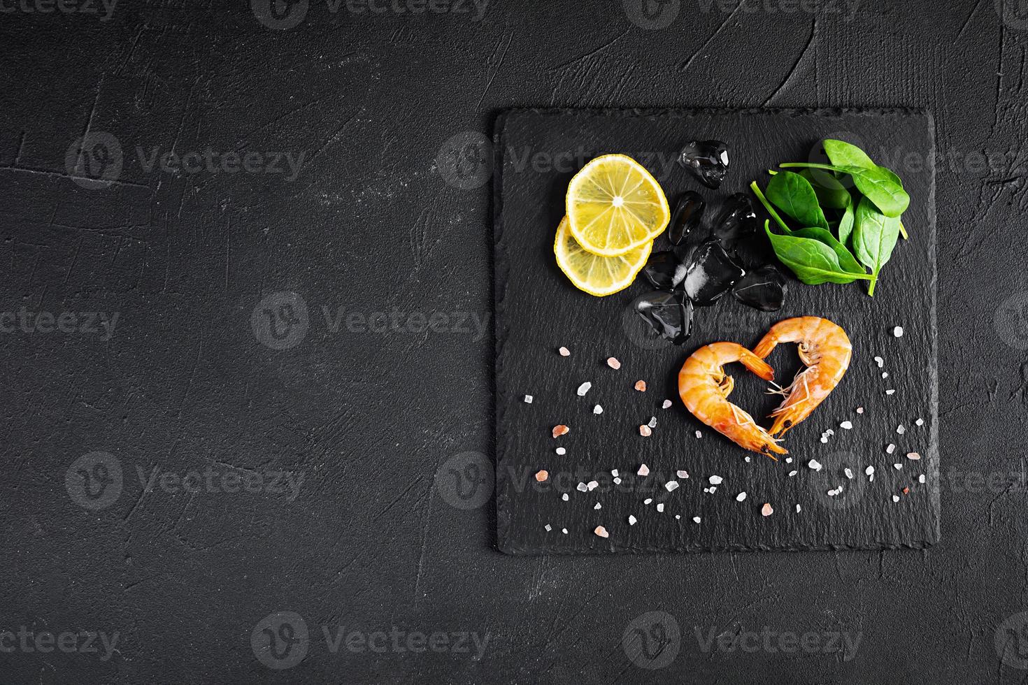 Delicious cooked shrimps isolated on dark background. Boiled prawns photo