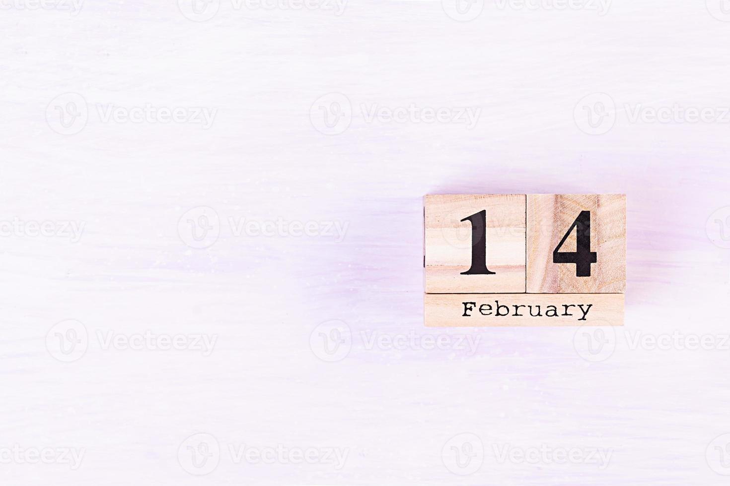 Valentine day. Wooden calendar with February 14 on it. photo