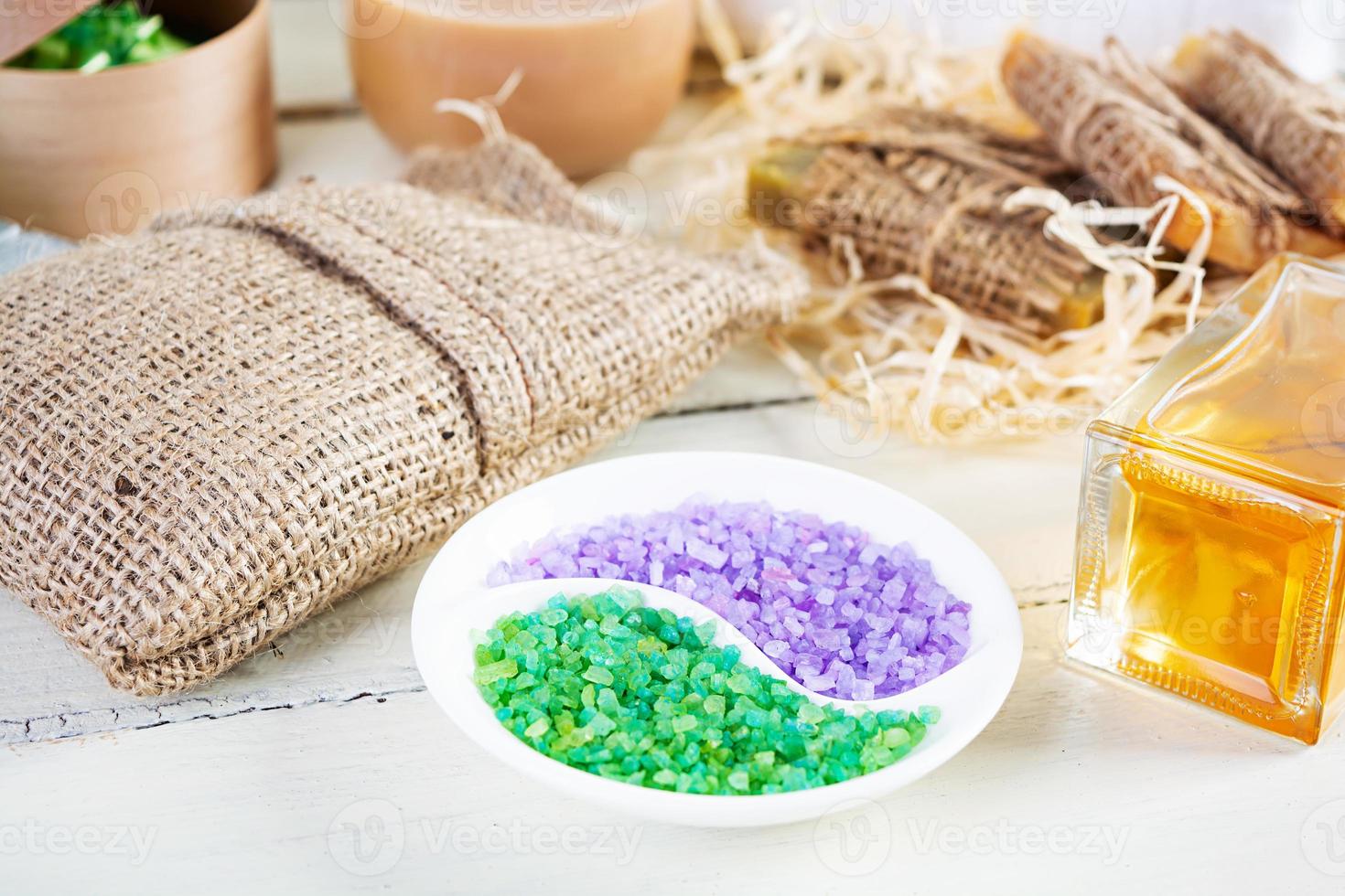 Different spa and bathroom products isolated on wooden background. Products for beauty treatments and body care photo