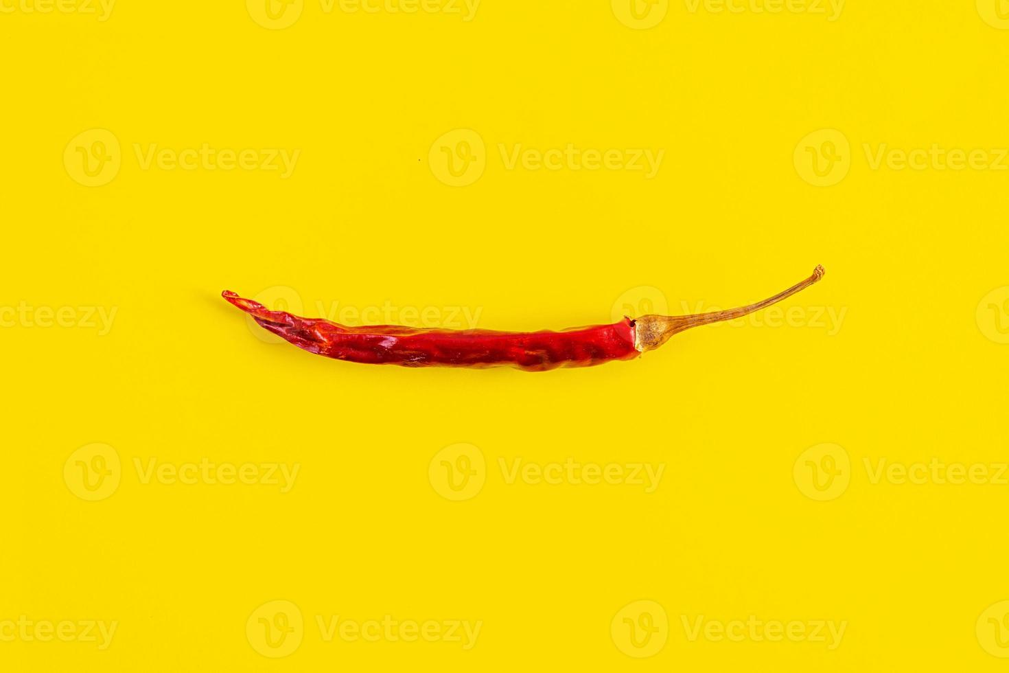 pimiento rojo seco sobre fondo amarillo. textura de chiles aislados foto