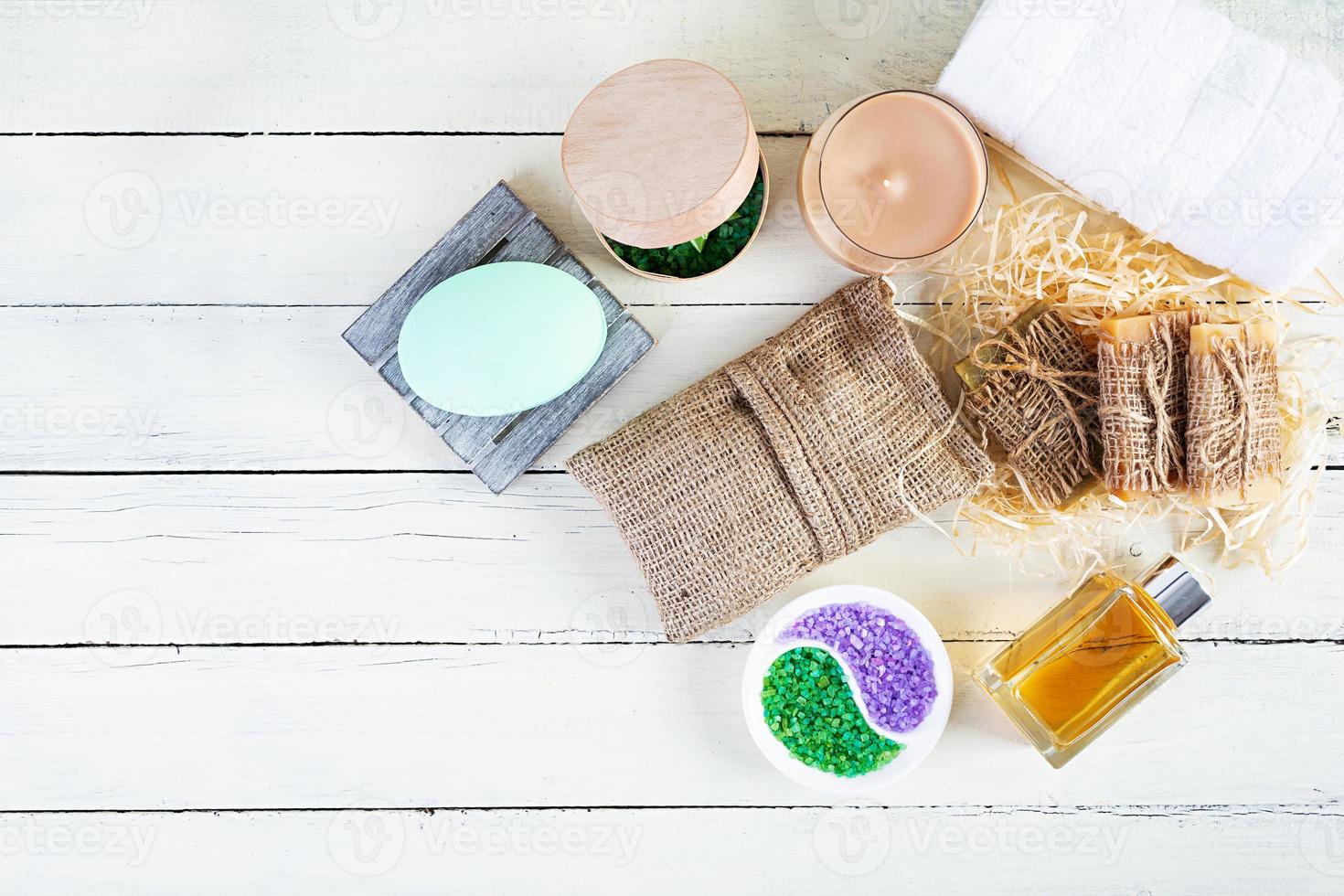 Different spa and bathroom products isolated on wooden background. Products for beauty treatments and body care photo