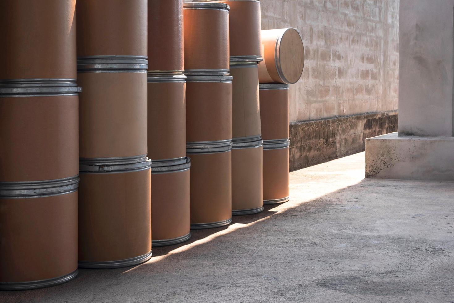 Side view of many old brown paper buckets for reuse on concrete floor in storage area photo