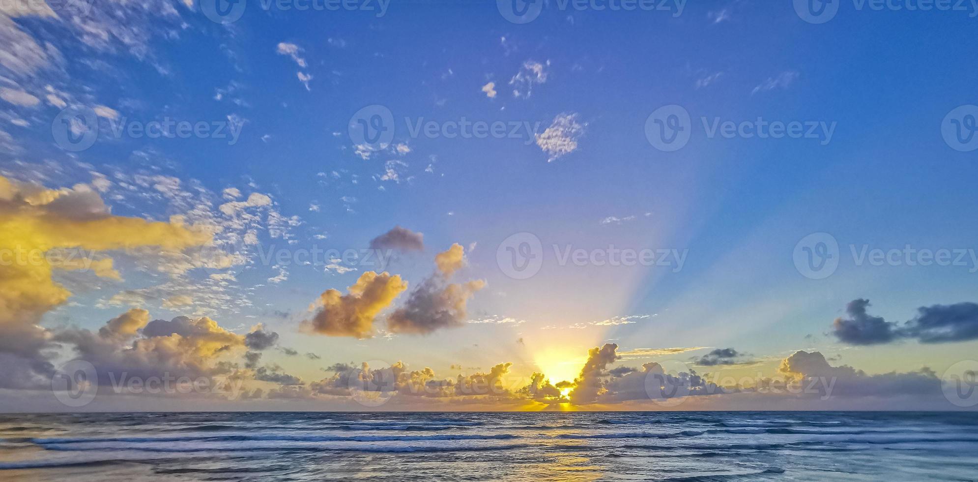 Golden colorful sunrise sunset with sunbeams tropical beach Tulum Mexico. photo