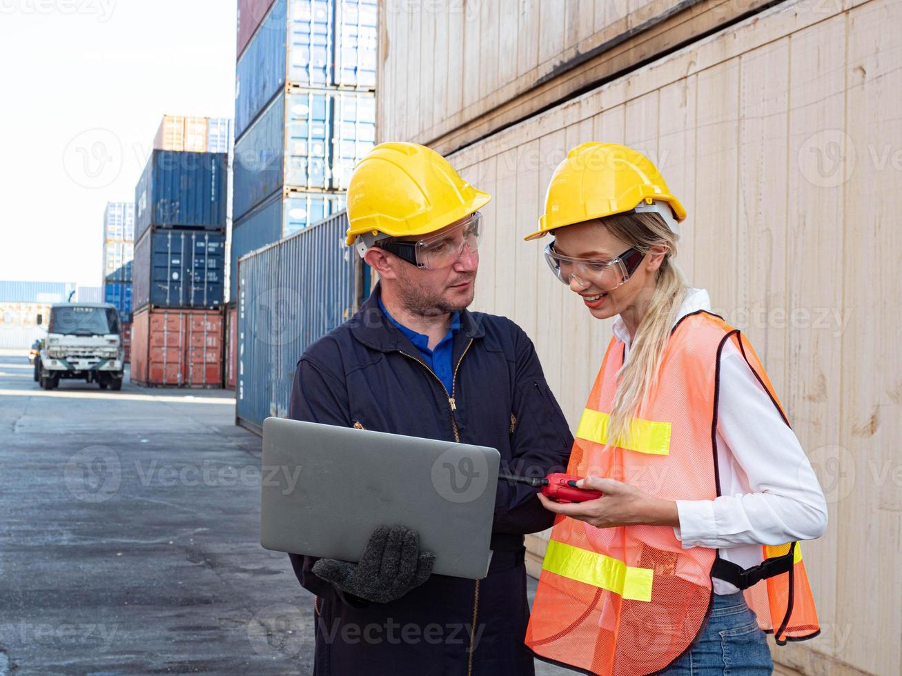 Foreman engineer female employee look at computer notebook talk discuss work job career businessman boss company office import export technology trade container logistic cargo forklift industry photo