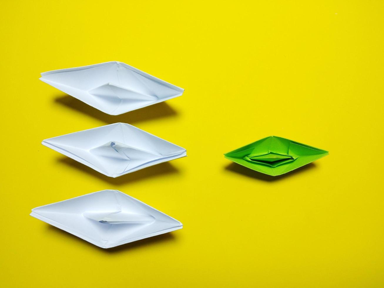 white and green paper boat yellow background in an orderly manner, providing ideas, leadership and effective management give a feeling have solidarity success, love, happiness, great photo