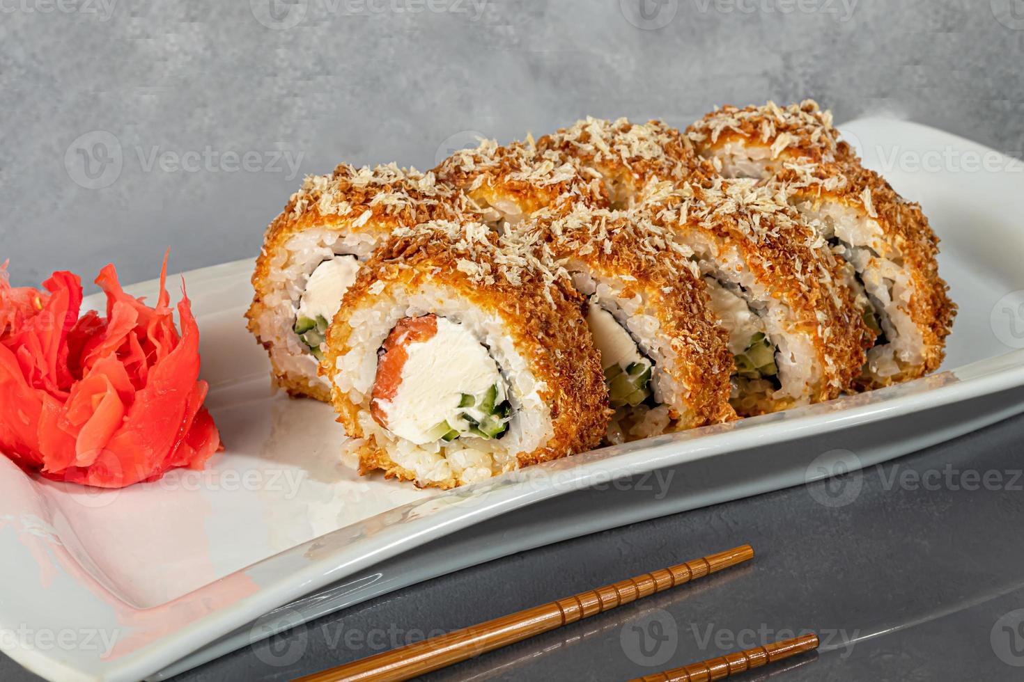 Sushi sets Uramaki, California, Philadelphia, rolls on a white plate. Menu for restaurants, cafes. On a dark reflective background. photo