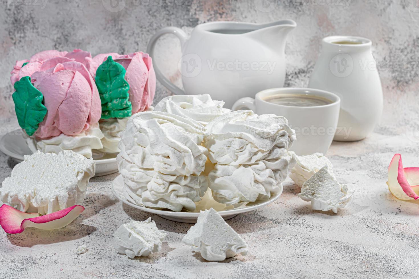 Handmade marshmallows on a light background in the form of roses, hydrangeas and tulips. There are flowers nearby. Women's day, Valentine's day. photo