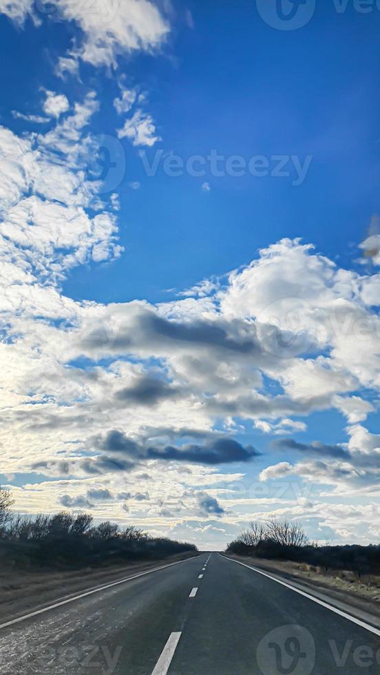 Blue sky with clouds. Road, exit from the occupied territories. War in Ukraine. Escape from the aggressor. photo