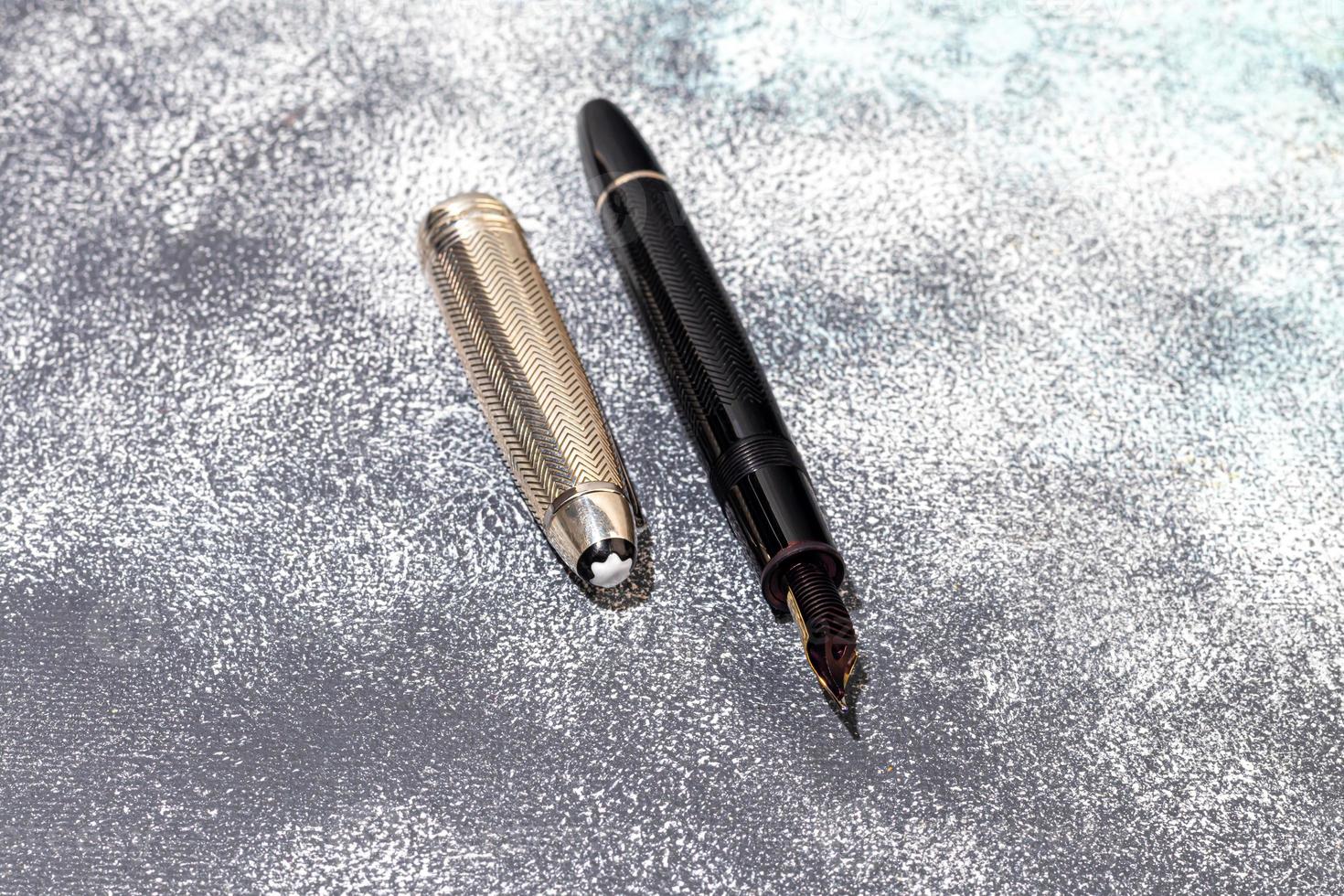 Fountain pen on a marble and gray background. Selective focus. photo