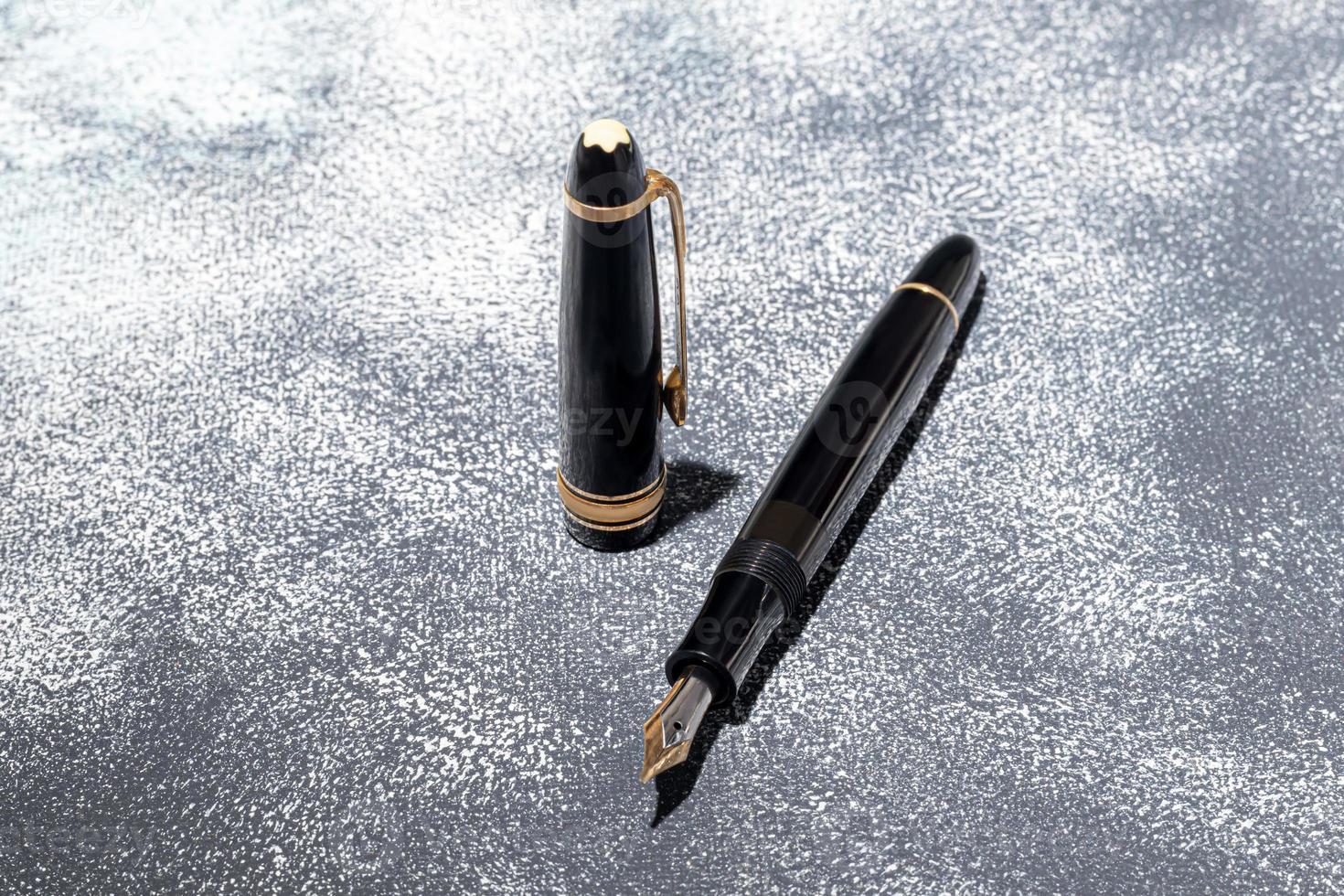 Fountain pen on a marble and gray background. Selective focus. photo