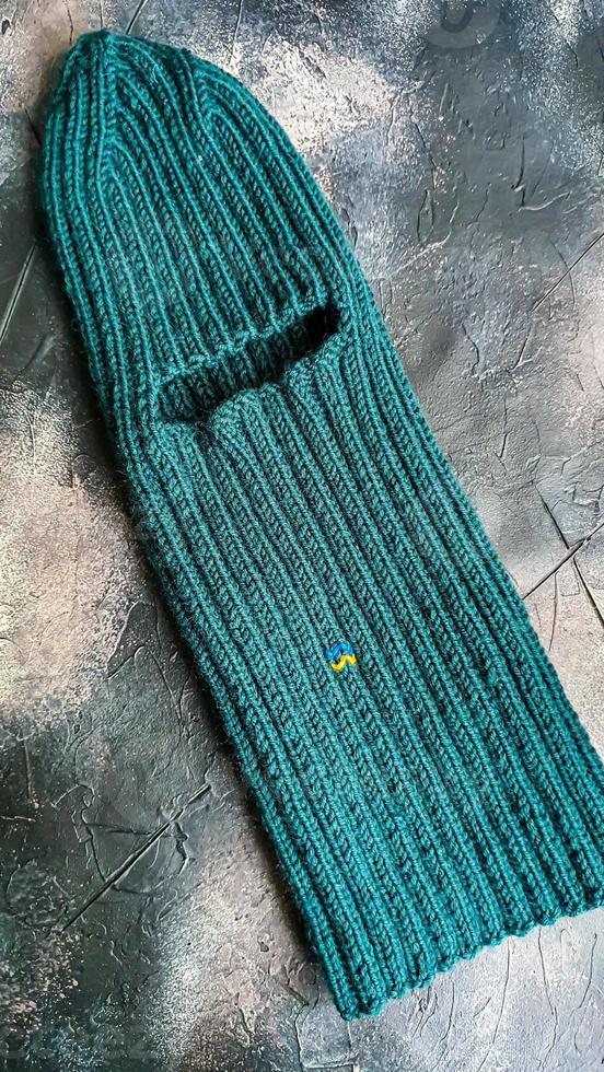 Handmade balaclava with Ukrainian symbols. Knitted from gray and green threads. Warms, reliably saves from the cold. photo