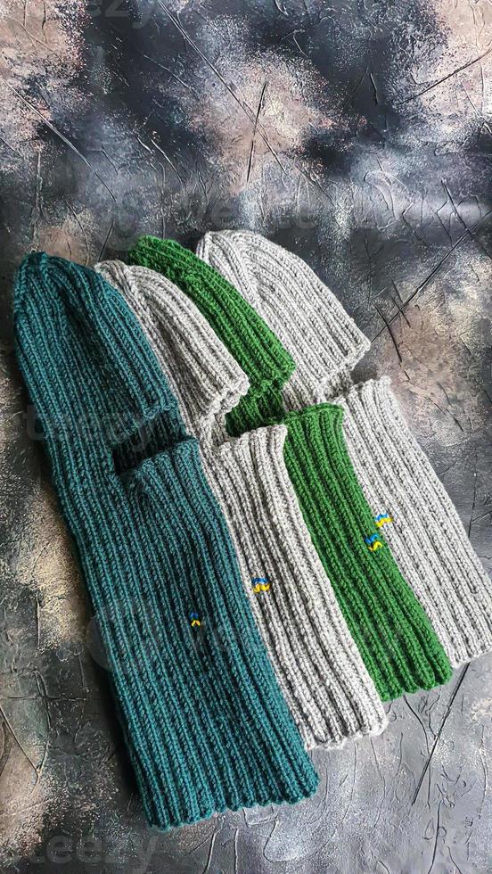 Handmade balaclava with Ukrainian symbols. Knitted from gray and green threads. Warms, reliably saves from the cold. photo