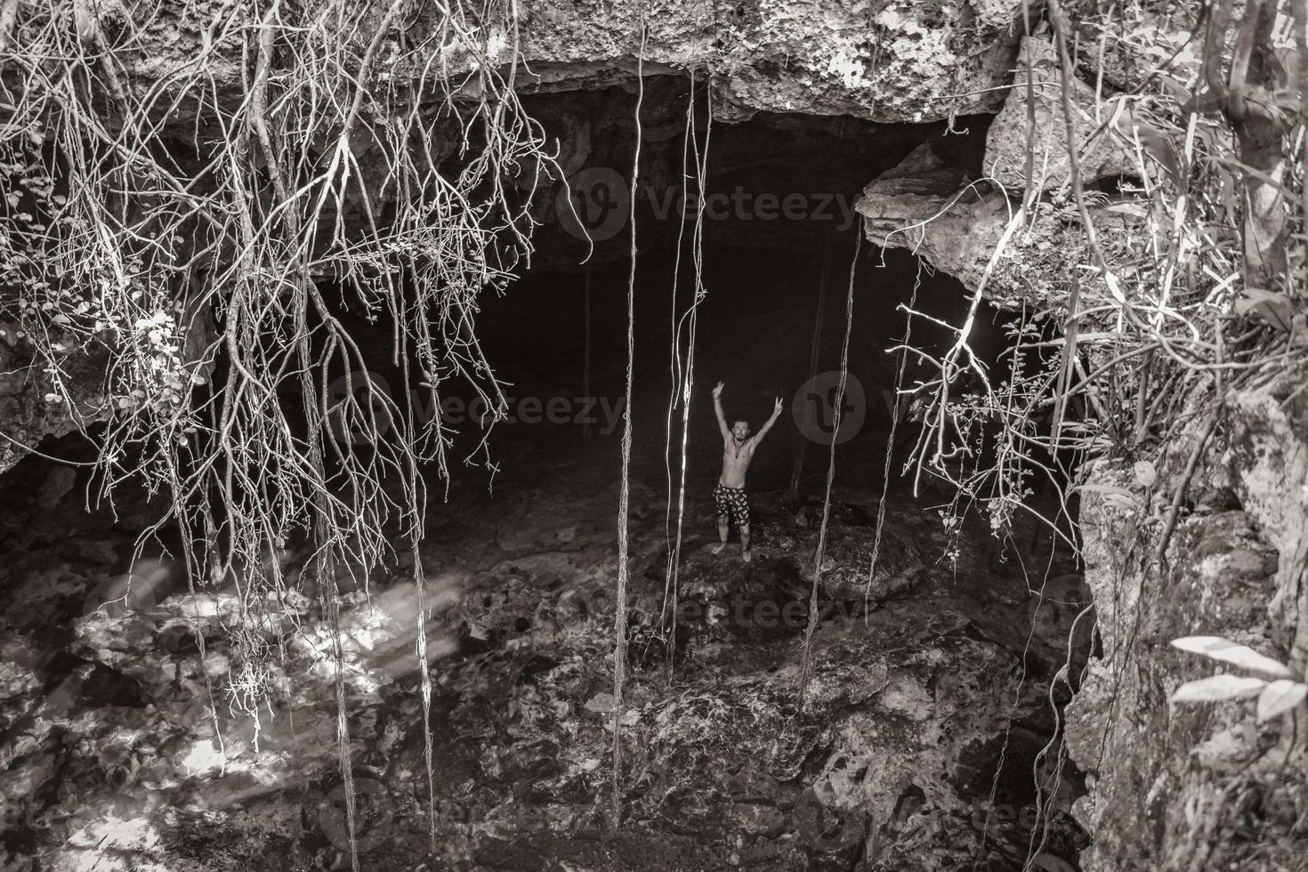 Tourist guide blue turquoise water limestone cave sinkhole cenote Mexico. photo