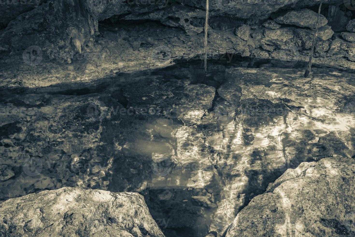 Blue turquoise water limestone cave sinkhole cenote Tajma ha Mexico. photo