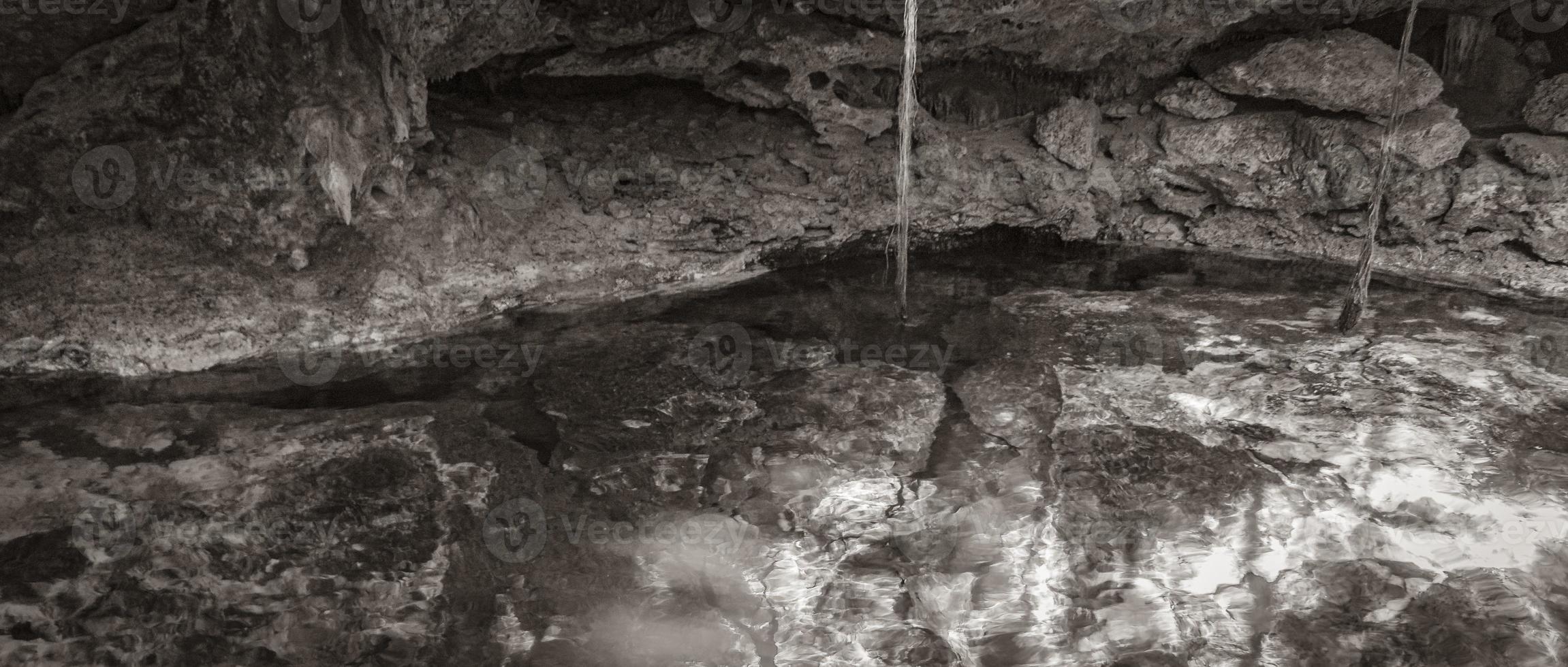 Blue turquoise water limestone cave sinkhole cenote Tajma ha Mexico. photo