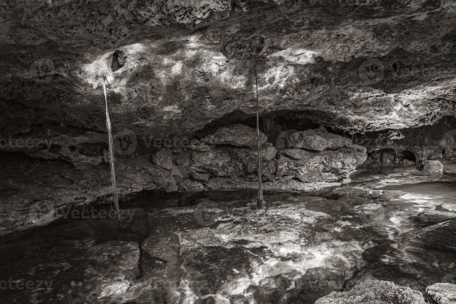 Blue turquoise water limestone cave sinkhole cenote Tajma ha Mexico. photo