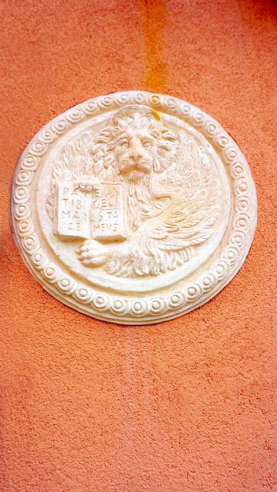 lion in circular shape bas relief art on orangel wall photo