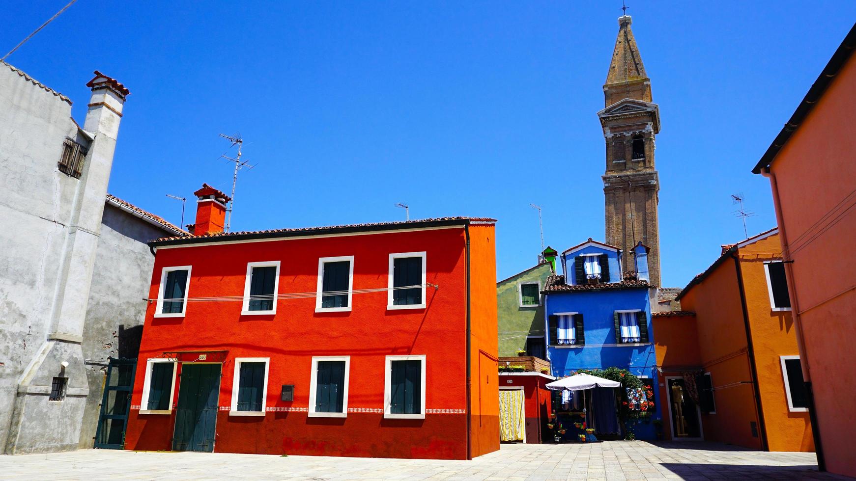 Burano colorful building architecture with church background photo