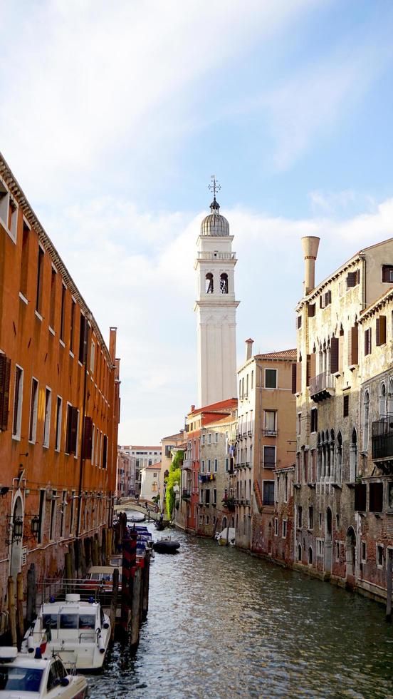 Scene of canal and boat with ancient architecture in Venice, Italy photo