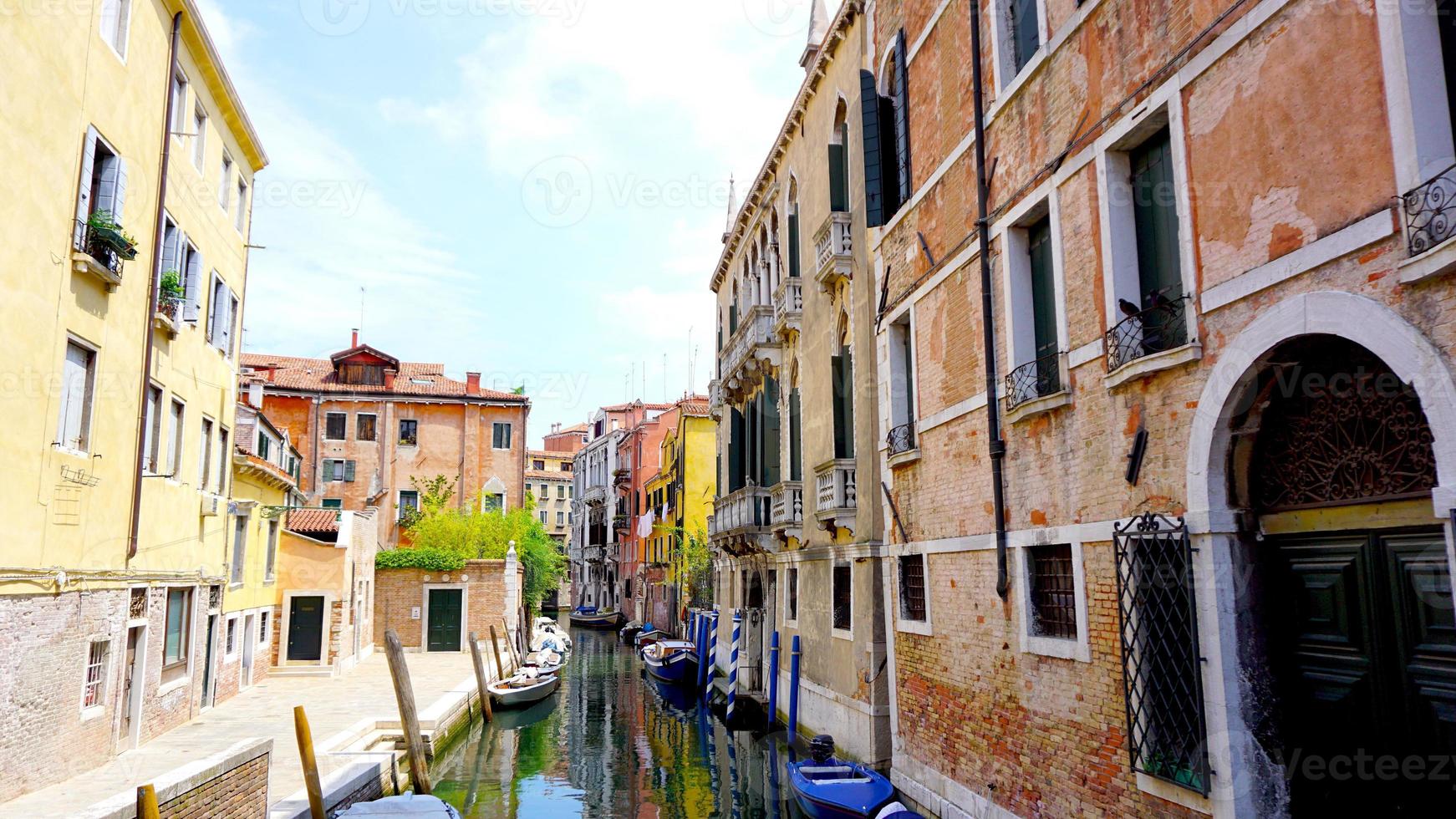 View of canal and boats with ancient architecture photo