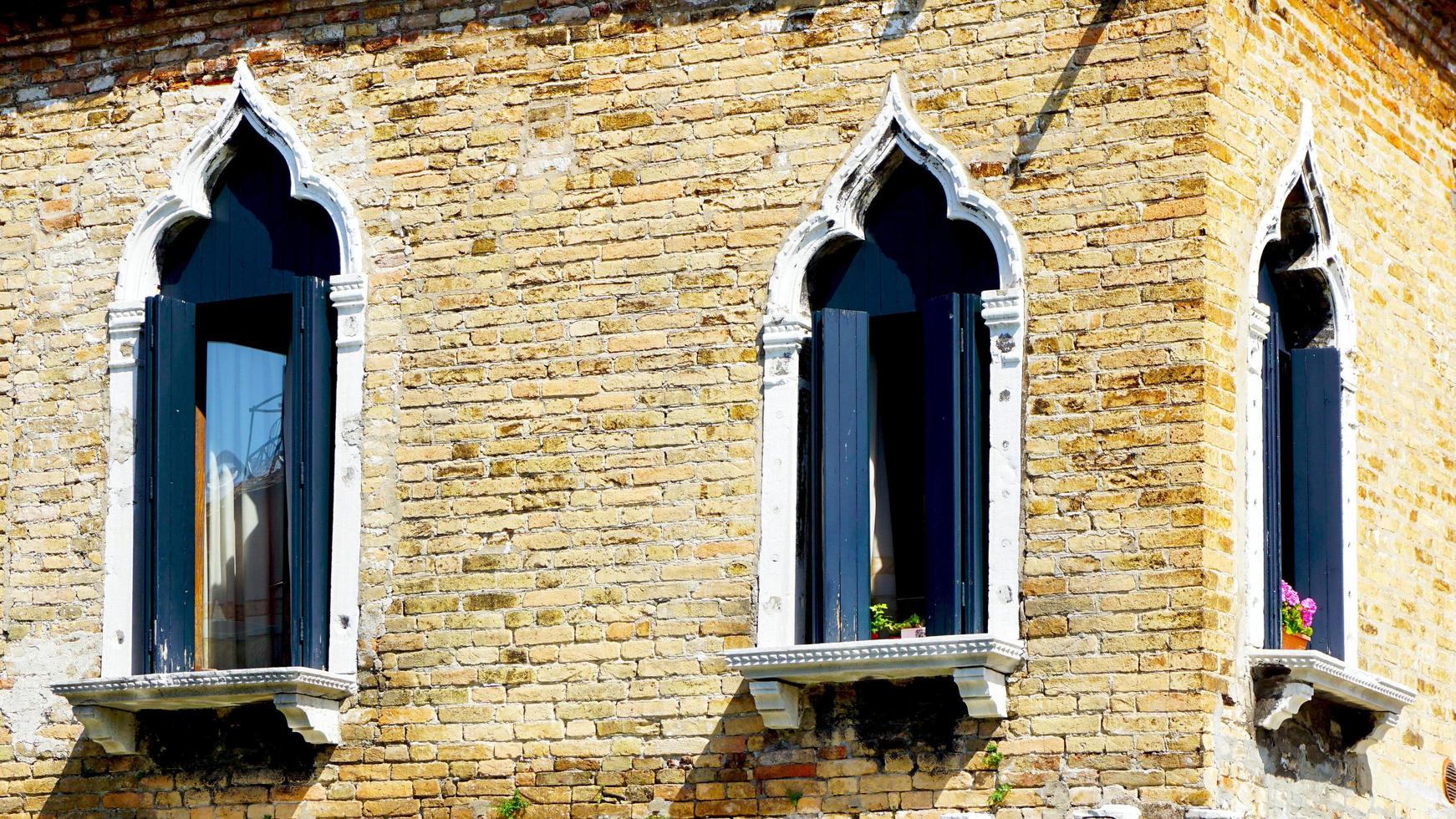 windows at coroner of house building in Venice, Italy photo