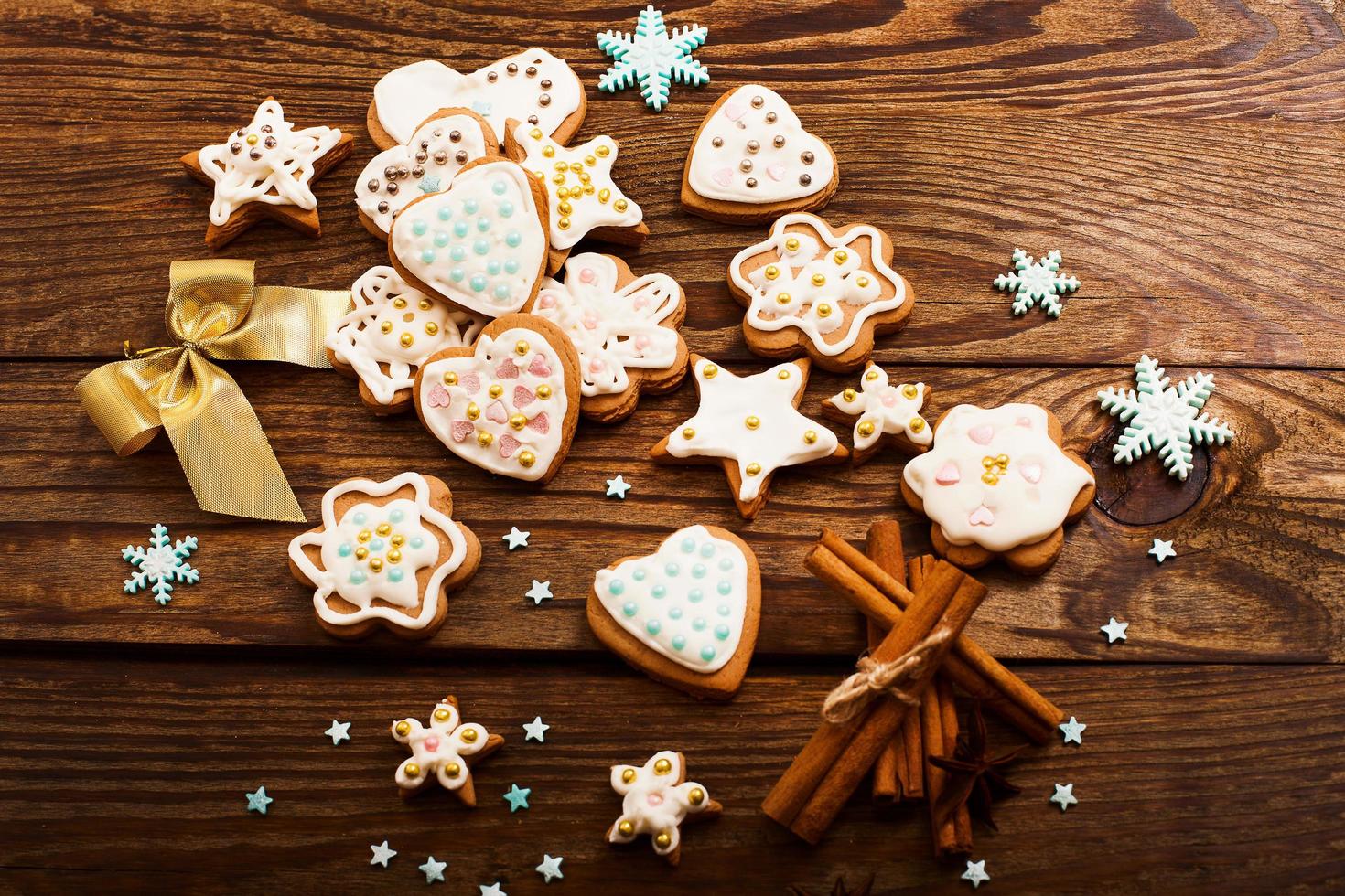 Frame of christmas sweet cookies on dark brown wooden background. Top view and copy space. Mock up. Happy new year concept photo