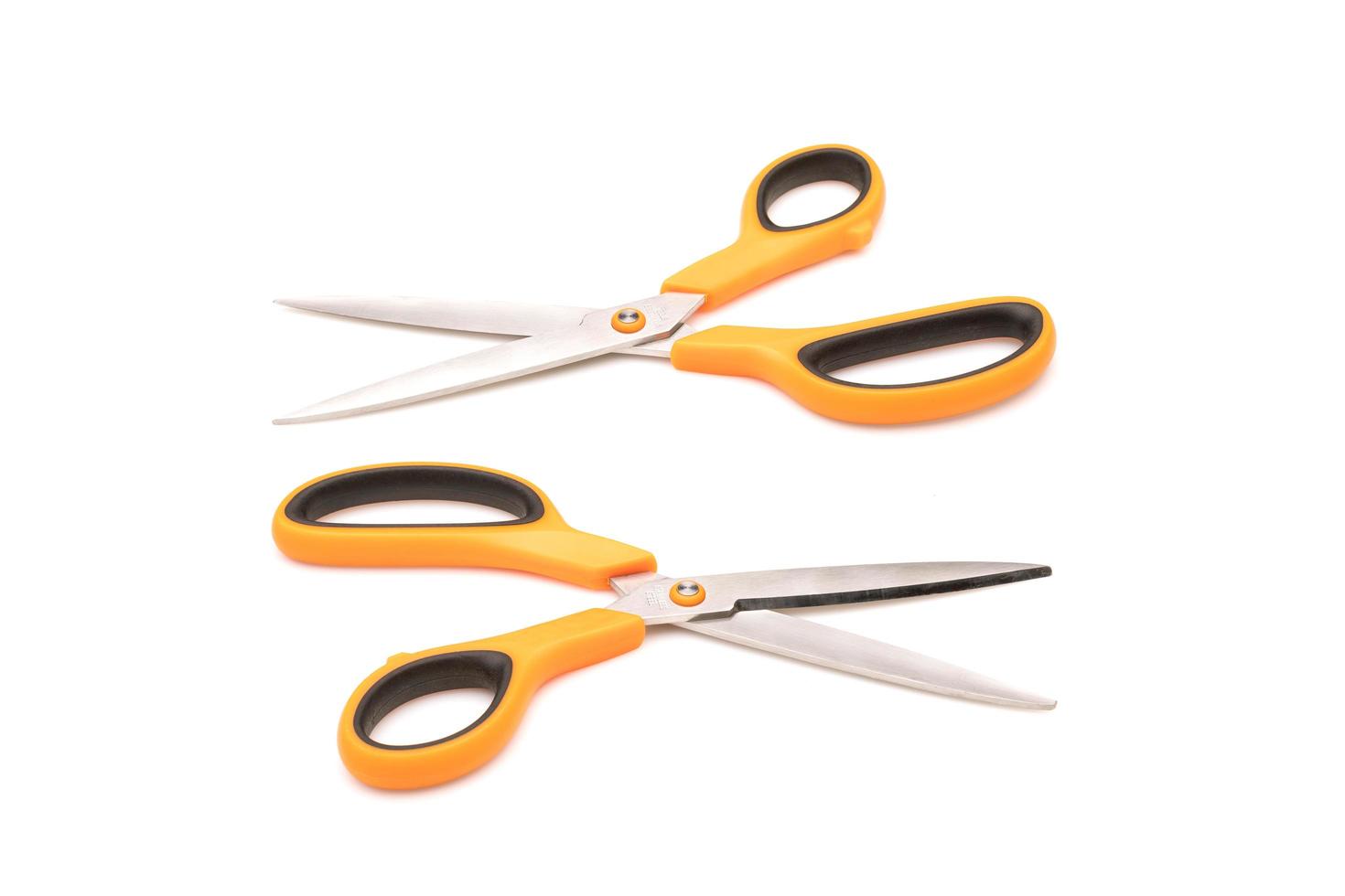 New scissor with orange and black color on handle isolated on white photo