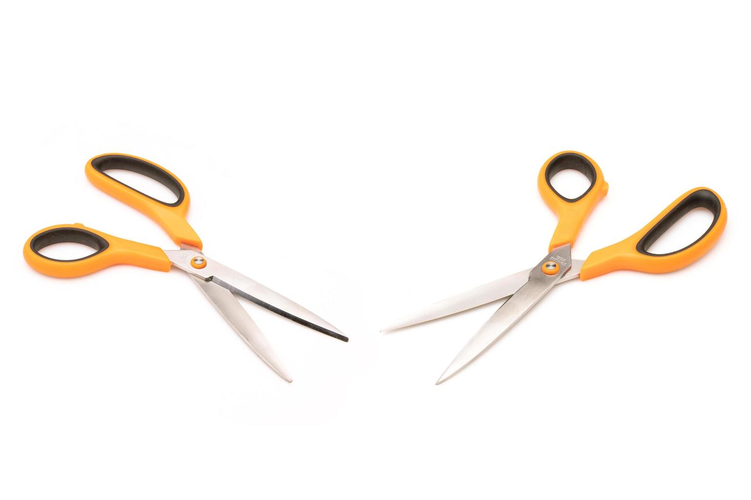 New scissor with orange and black color on handle isolated on white photo