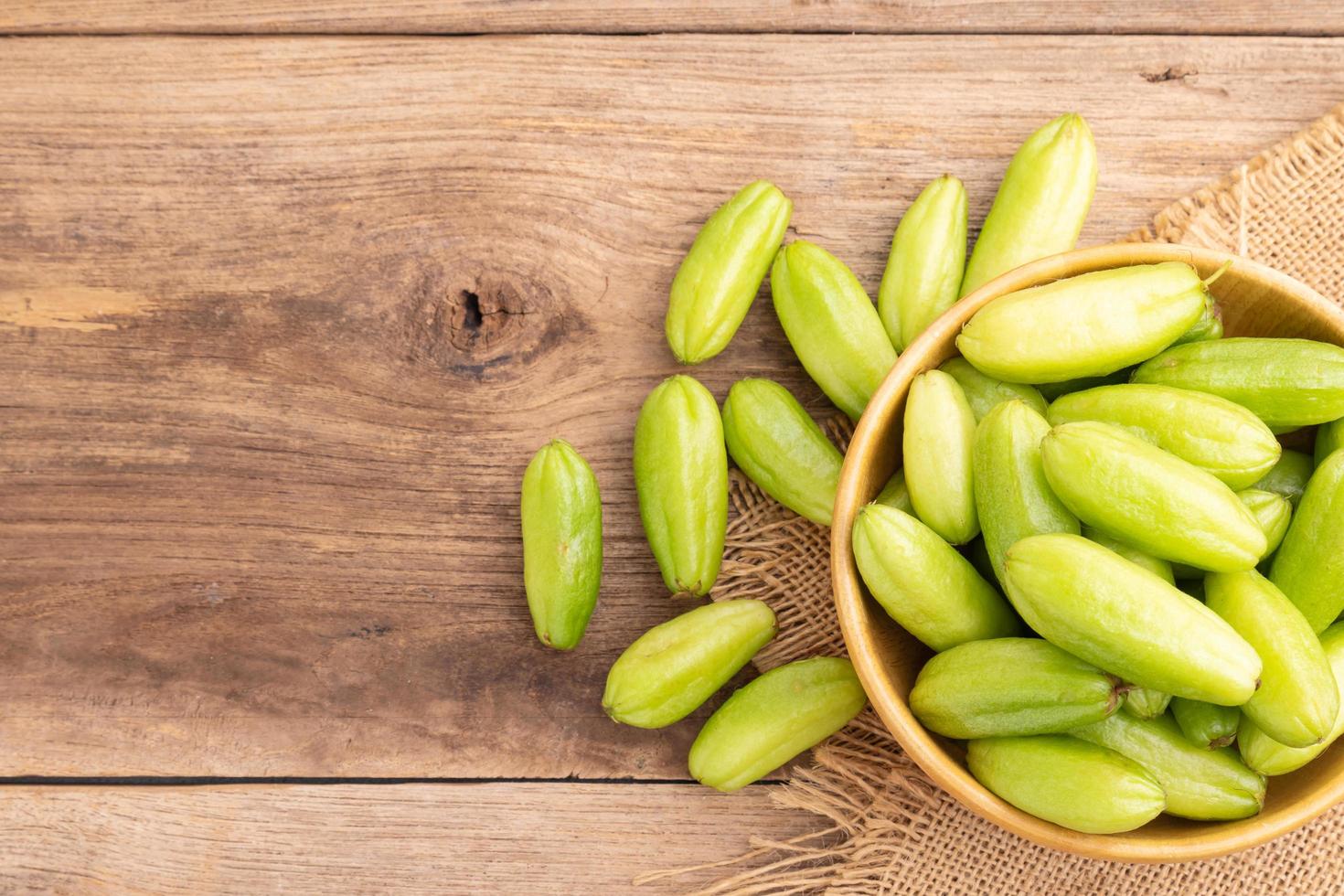 Bilimbi fruit or Averrhoa bilimbi on wooden table background. Food and healthcare concept photo