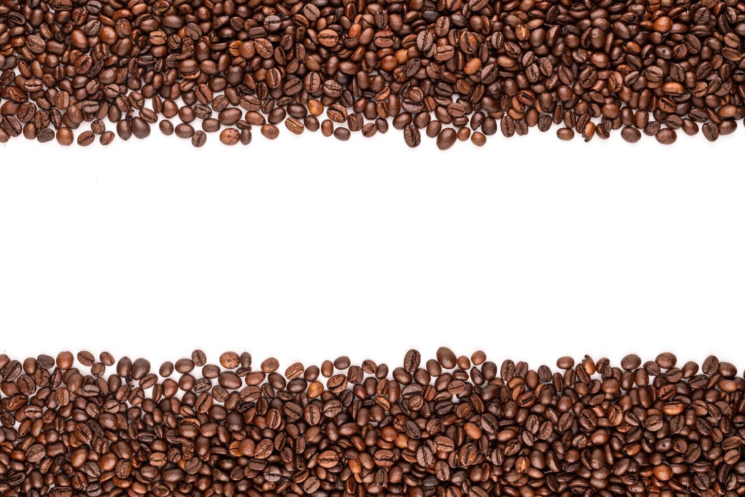 Roasted coffee beans. Top view brown coffee beans texture isolated on white photo