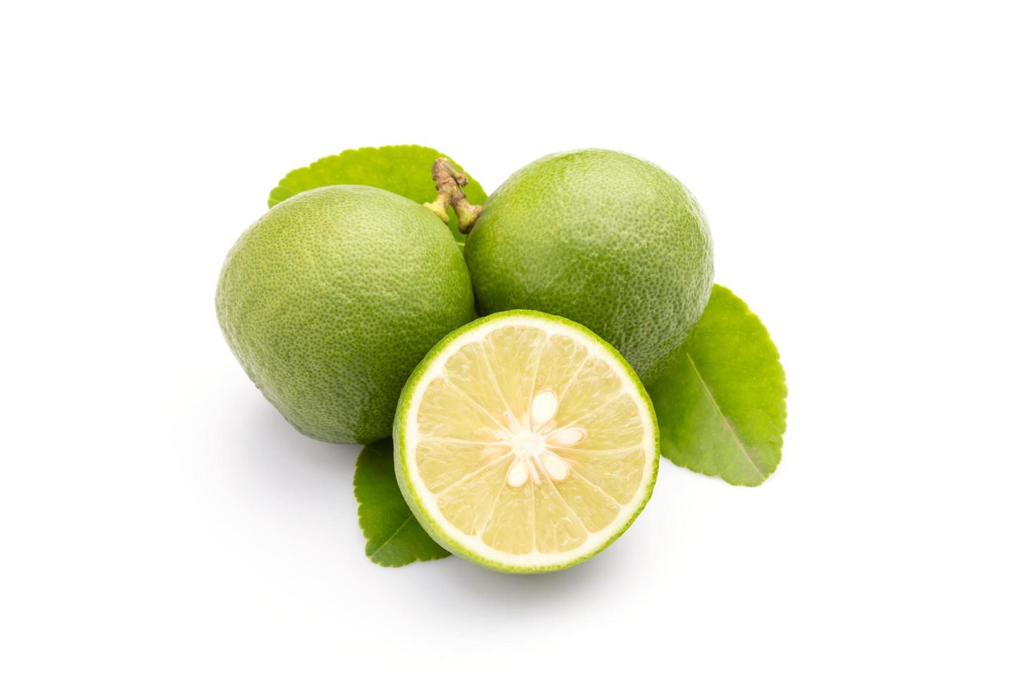 Slice of Thai Lime Common Lime or local lime isolated on white background. Food and healthcare concept photo