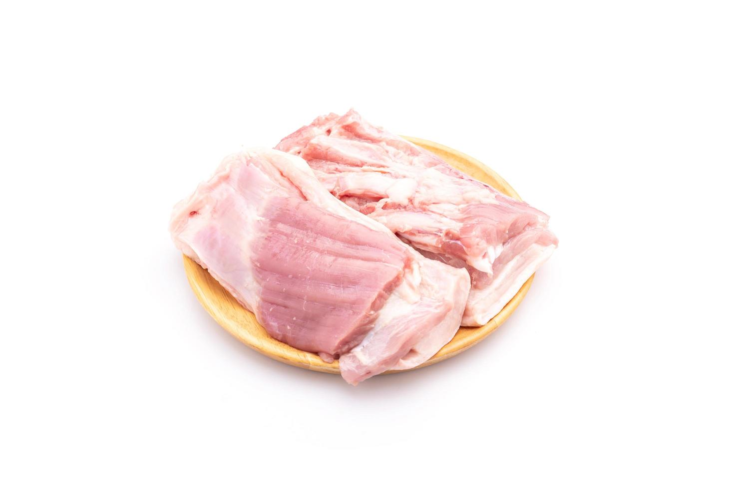 Raw streaky pork on wooden dish isolated on white background. Food and healthcare concept photo