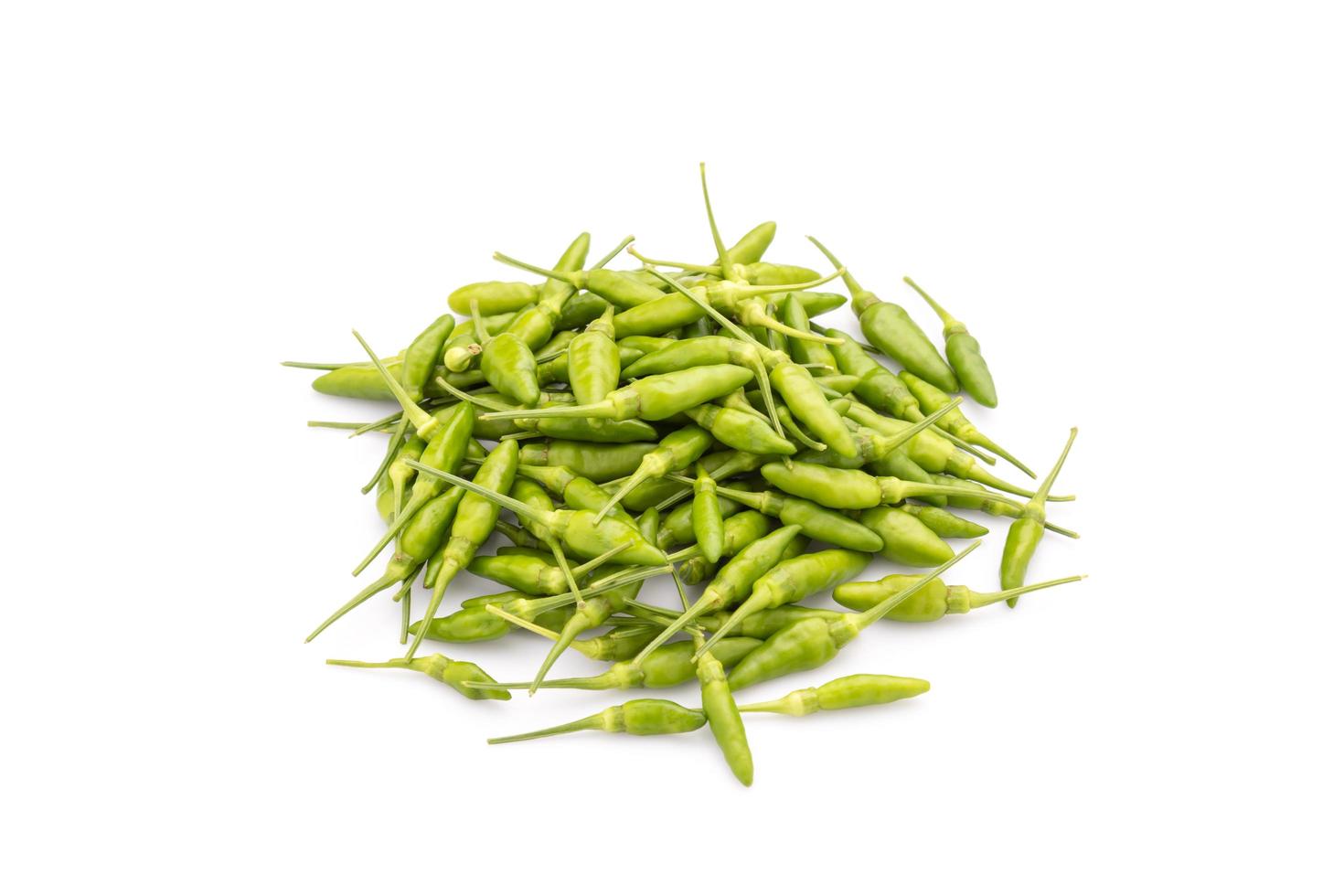 pile of green Bird Chilli or Thai pepper isolated on white photo