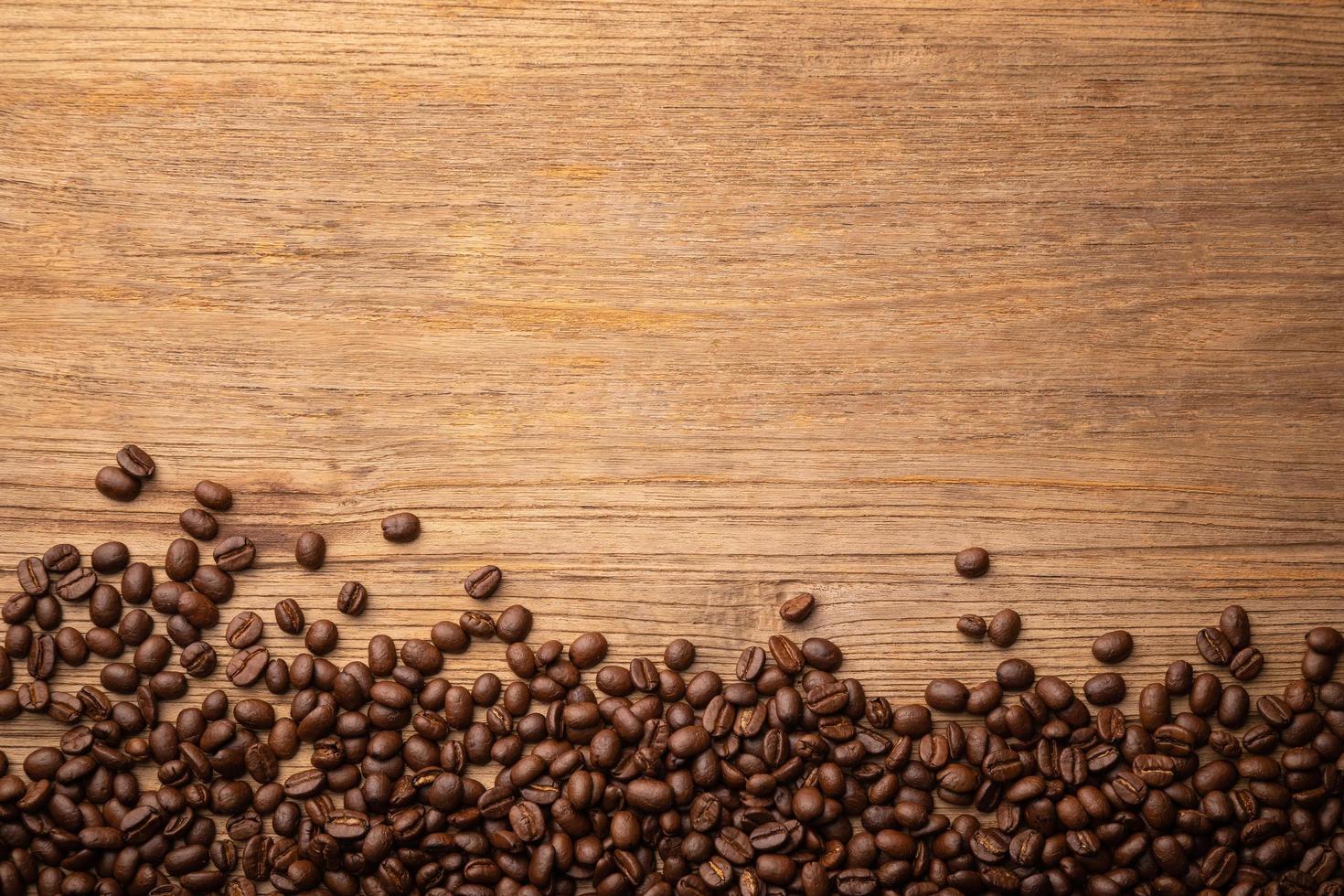 Coffee bean on wooden table background. Food and beverage concept photo