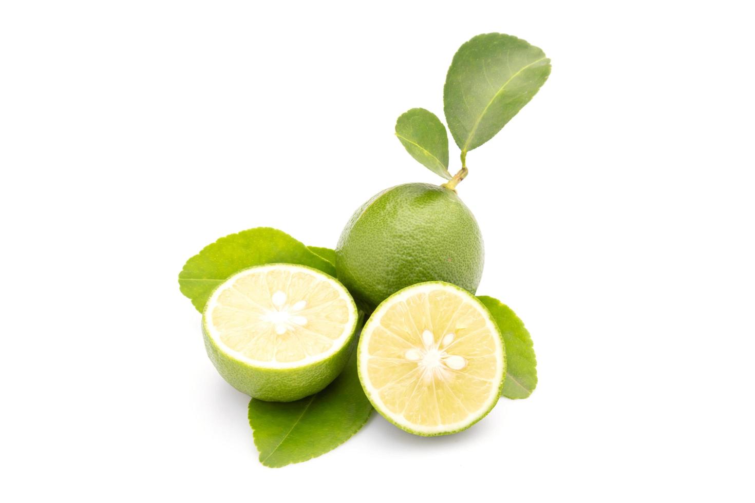 Slice of Thai Lime Common Lime or local lime isolated on white background. Food and healthcare concept photo