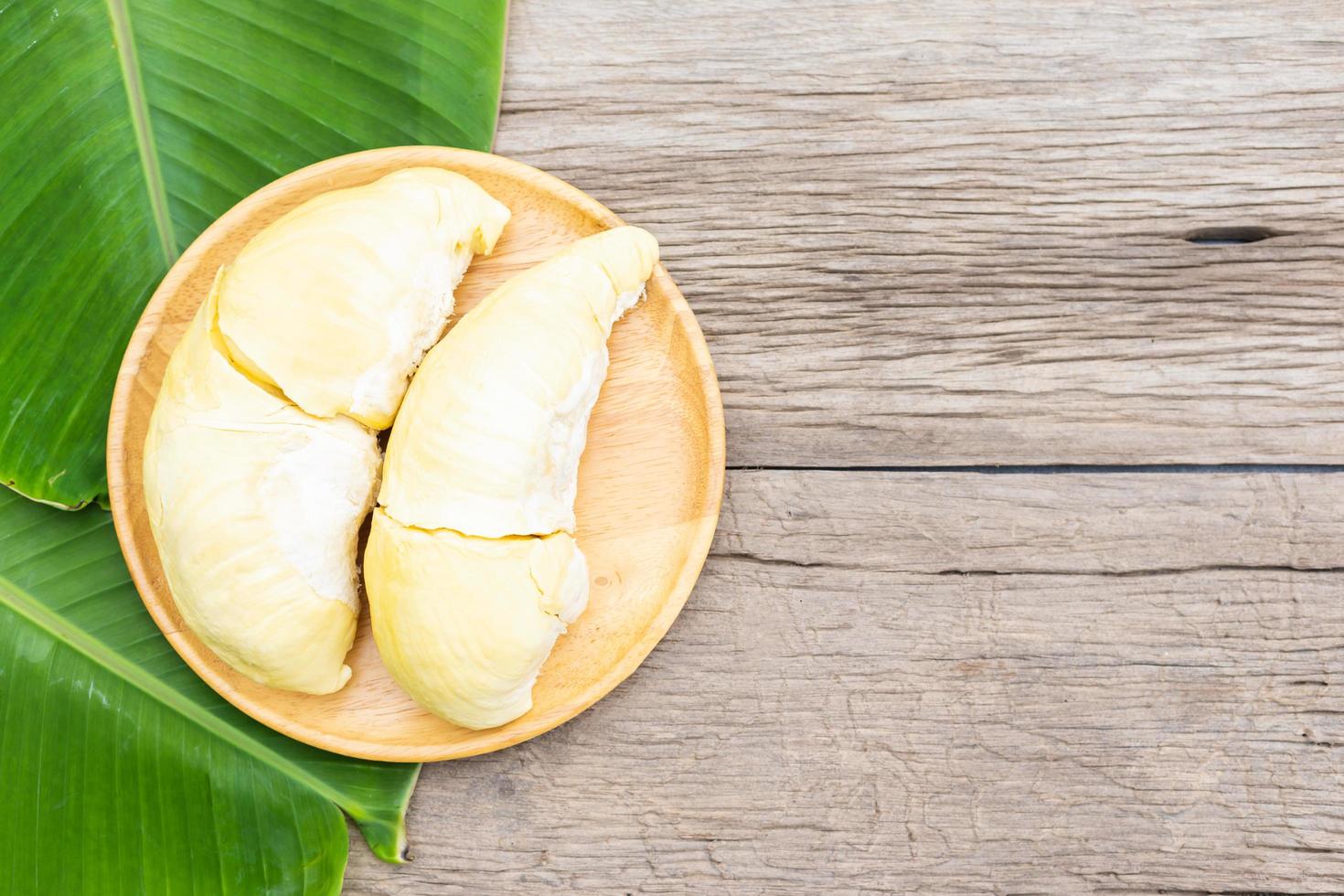 Durian fruit on wooden dish on wood table with copy space photo