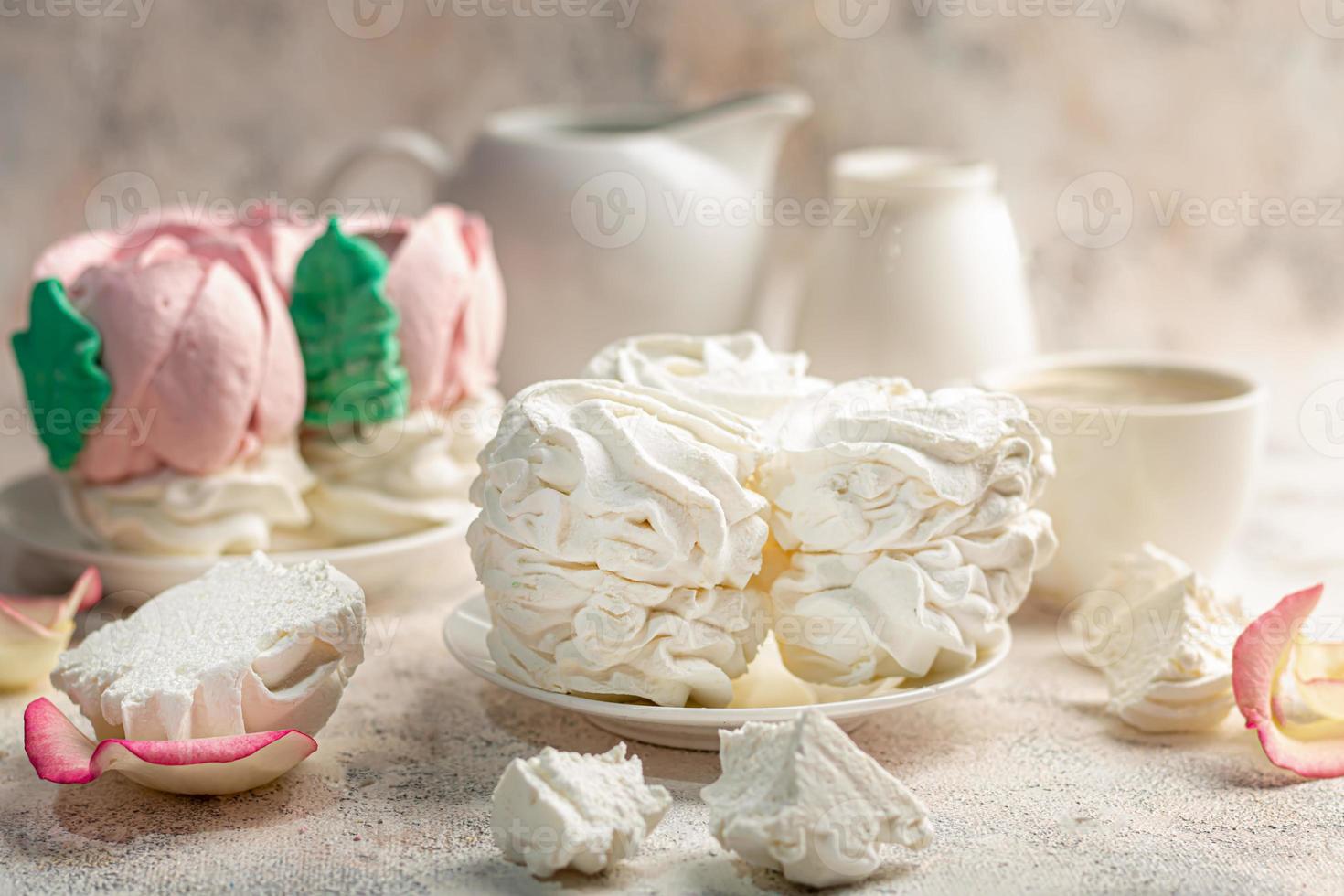 Handmade marshmallows on a light background in the form of roses, hydrangeas and tulips. There are flowers nearby. Women's day, Valentine's day. photo