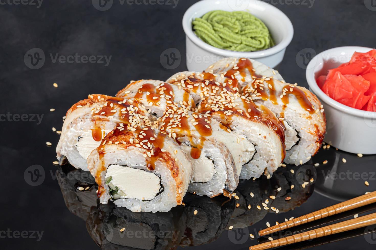 Sushi sets Uramaki, California, Philadelphia, rolls on a white plate. Menu for restaurants, cafes. On a dark reflective background. photo