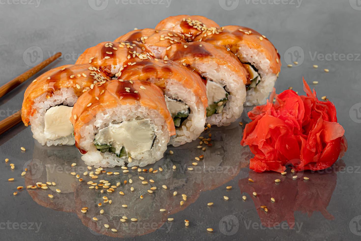 Sushi sets Uramaki, California, Philadelphia, rolls on a white plate. Menu for restaurants, cafes. On a dark reflective background. photo
